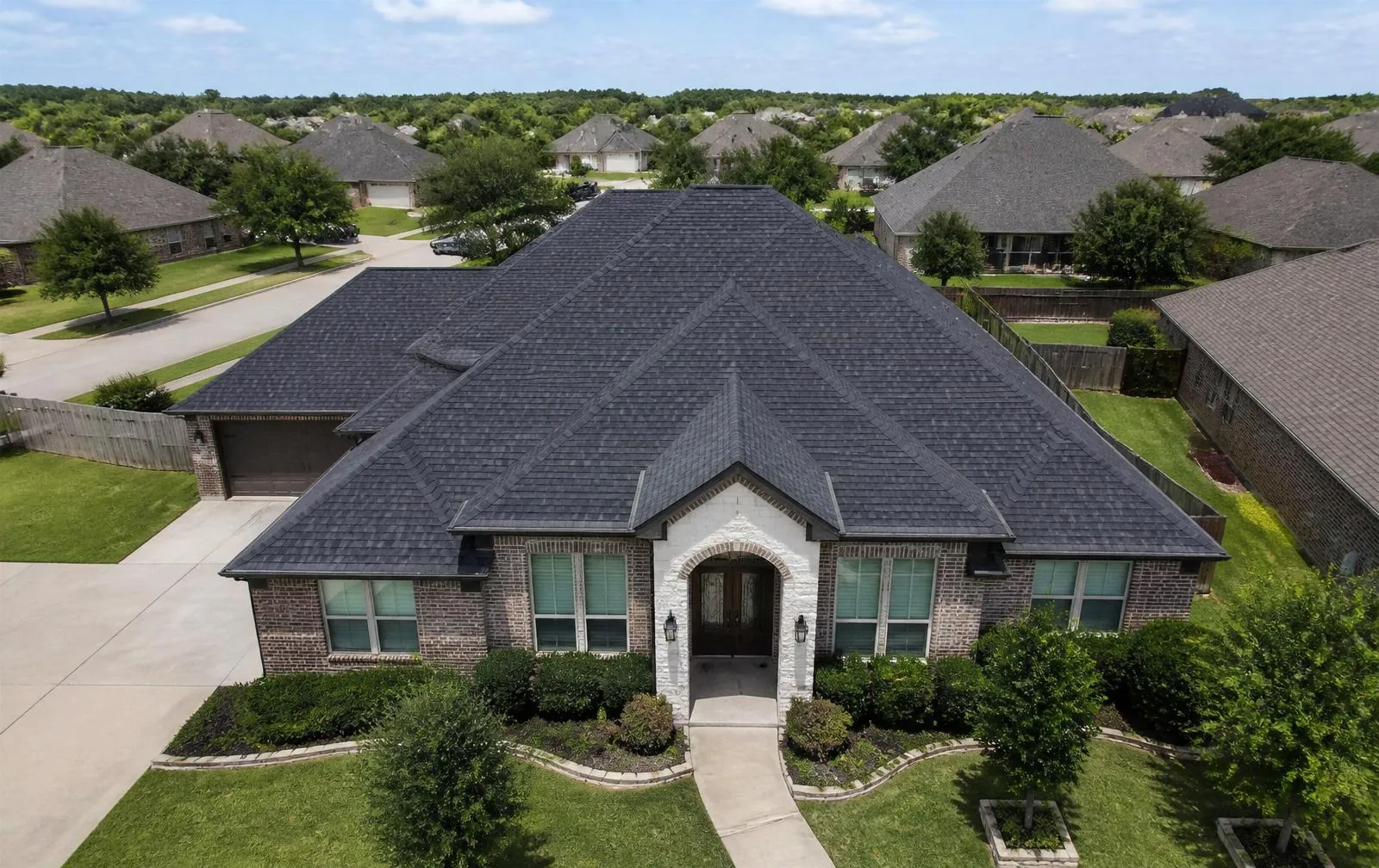 Aerial view of a completed residential roof replacement